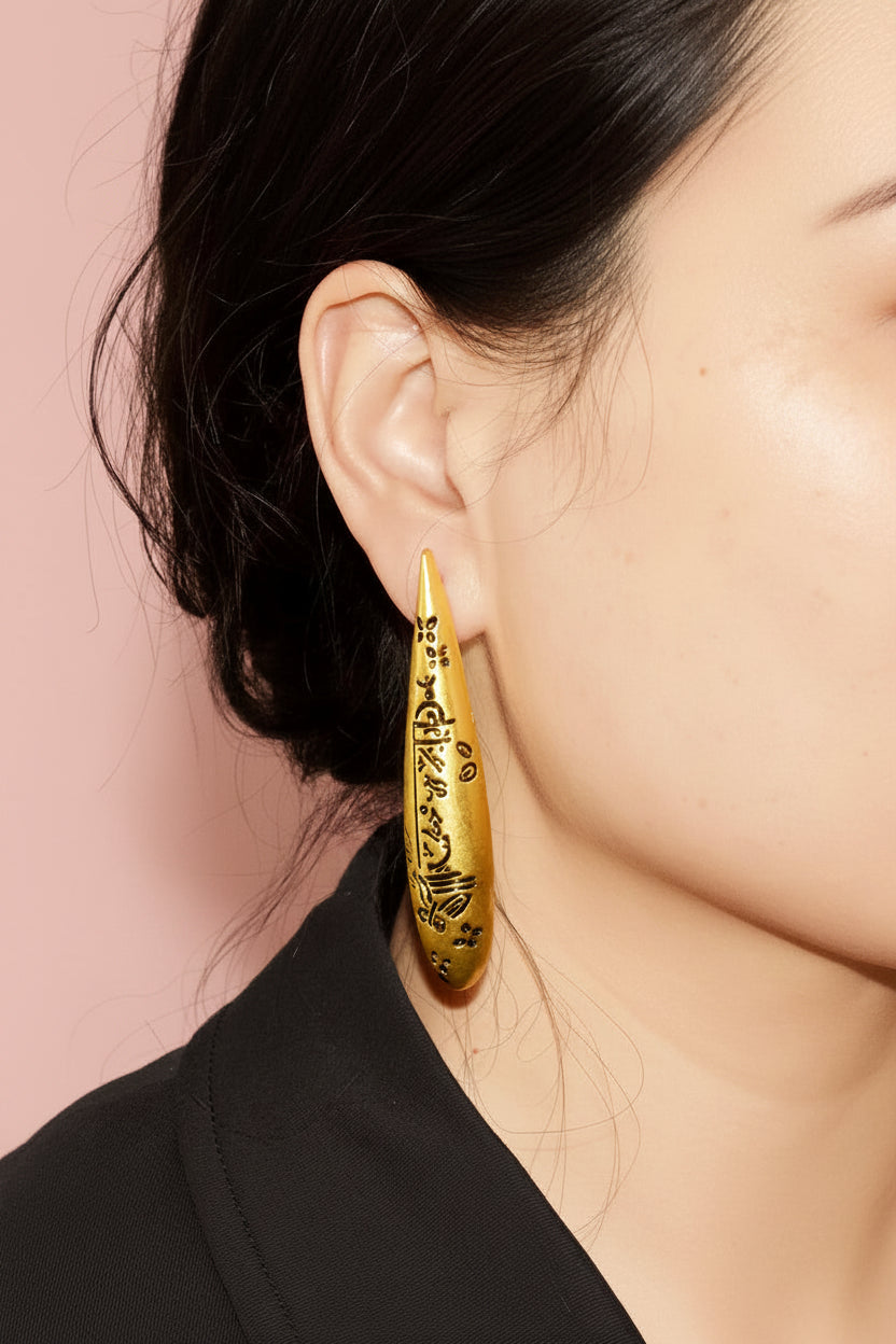 Engraved symbols long drop earrings