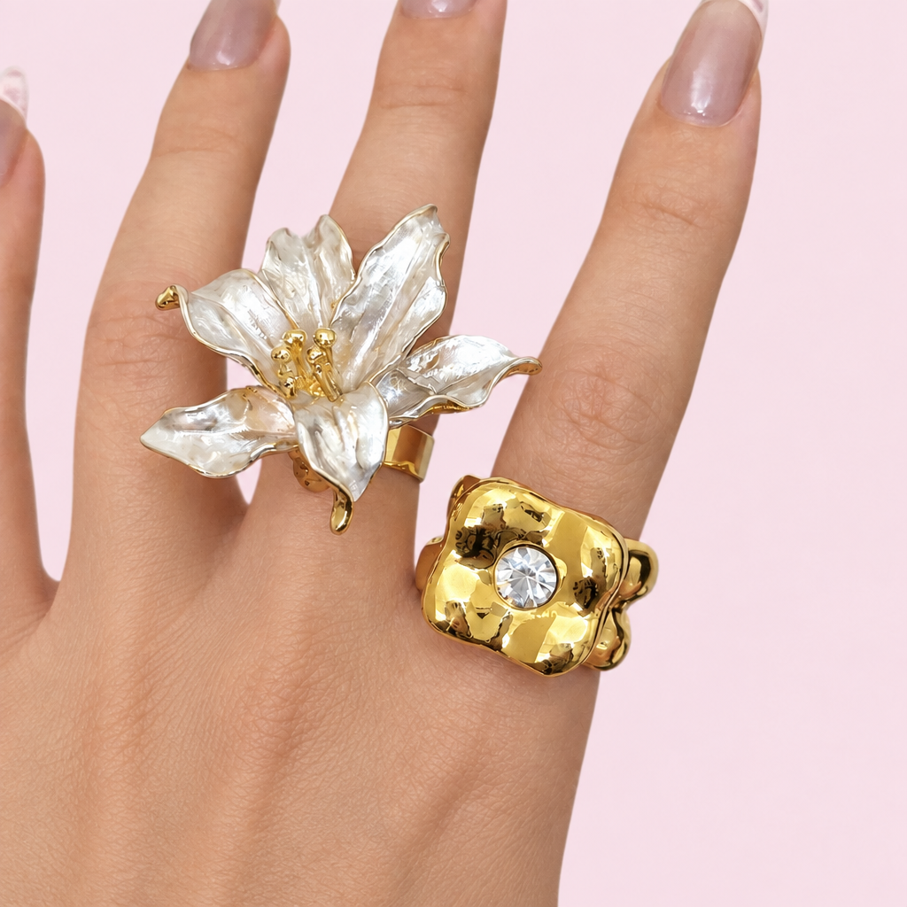 Surrealist rings on a hand against a light pink background