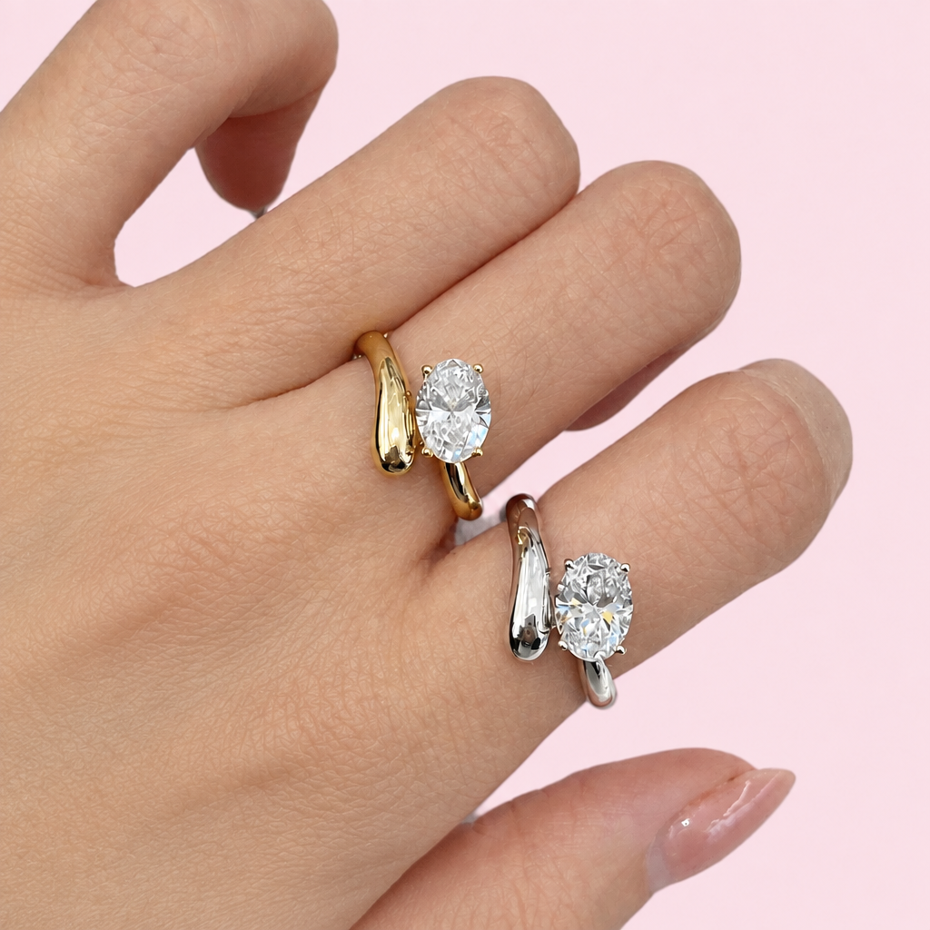 Exquisite Twist Zircon Rings without the blouse cuff on a light pink background